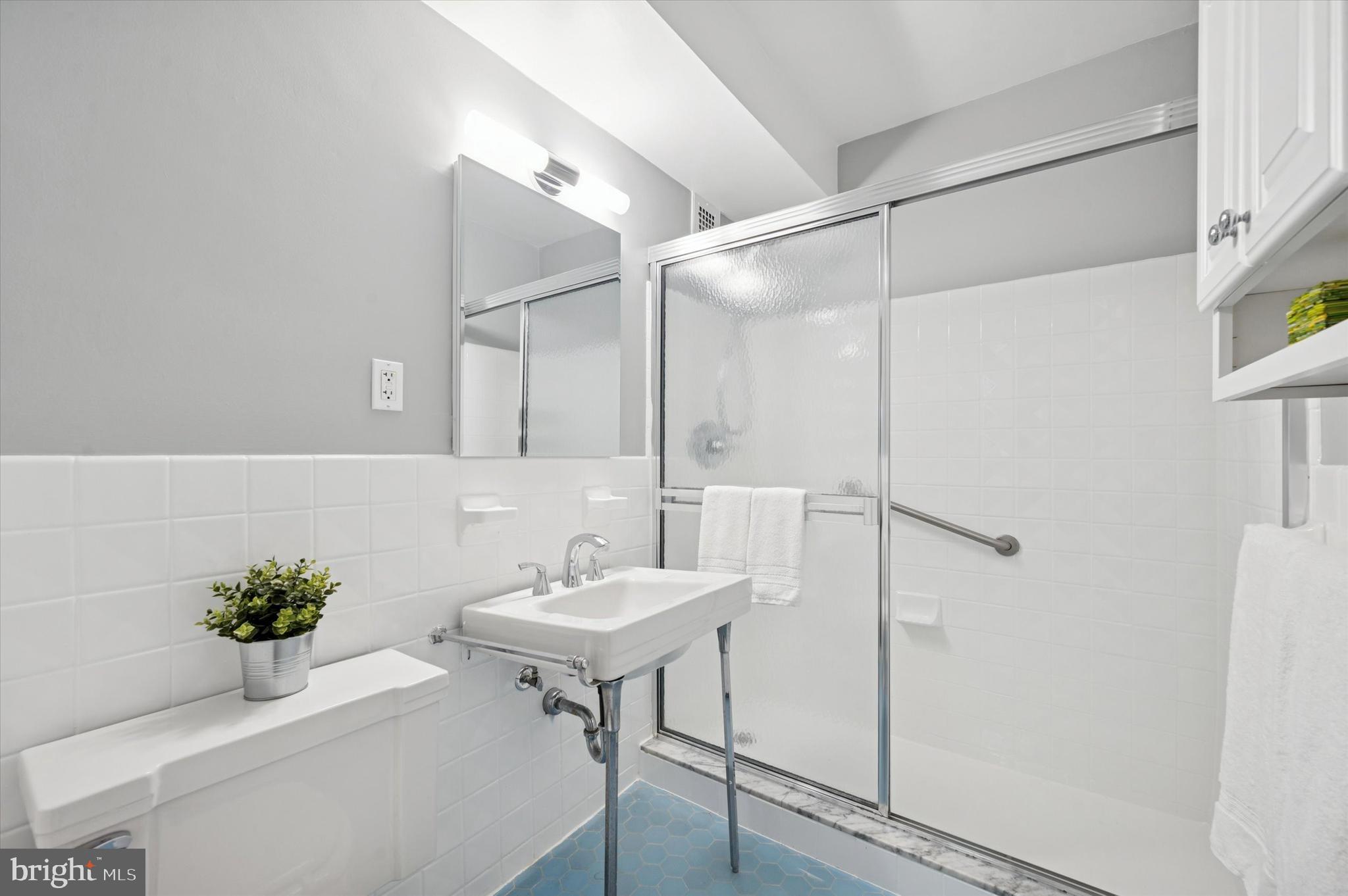 220 West Rittenhouse Square, Unit 6F Philadelphia, PA 19103 - Photo 25 of 26 a bathroom with a sink and a mirror