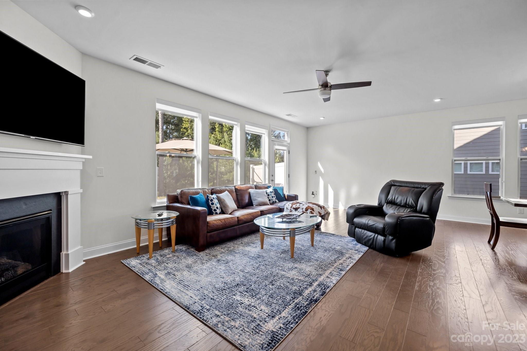 2075 Suttonview Road Fort Mill, SC 29708 - Photo 11 of 39 a living room with furniture a flat screen tv and a fireplace