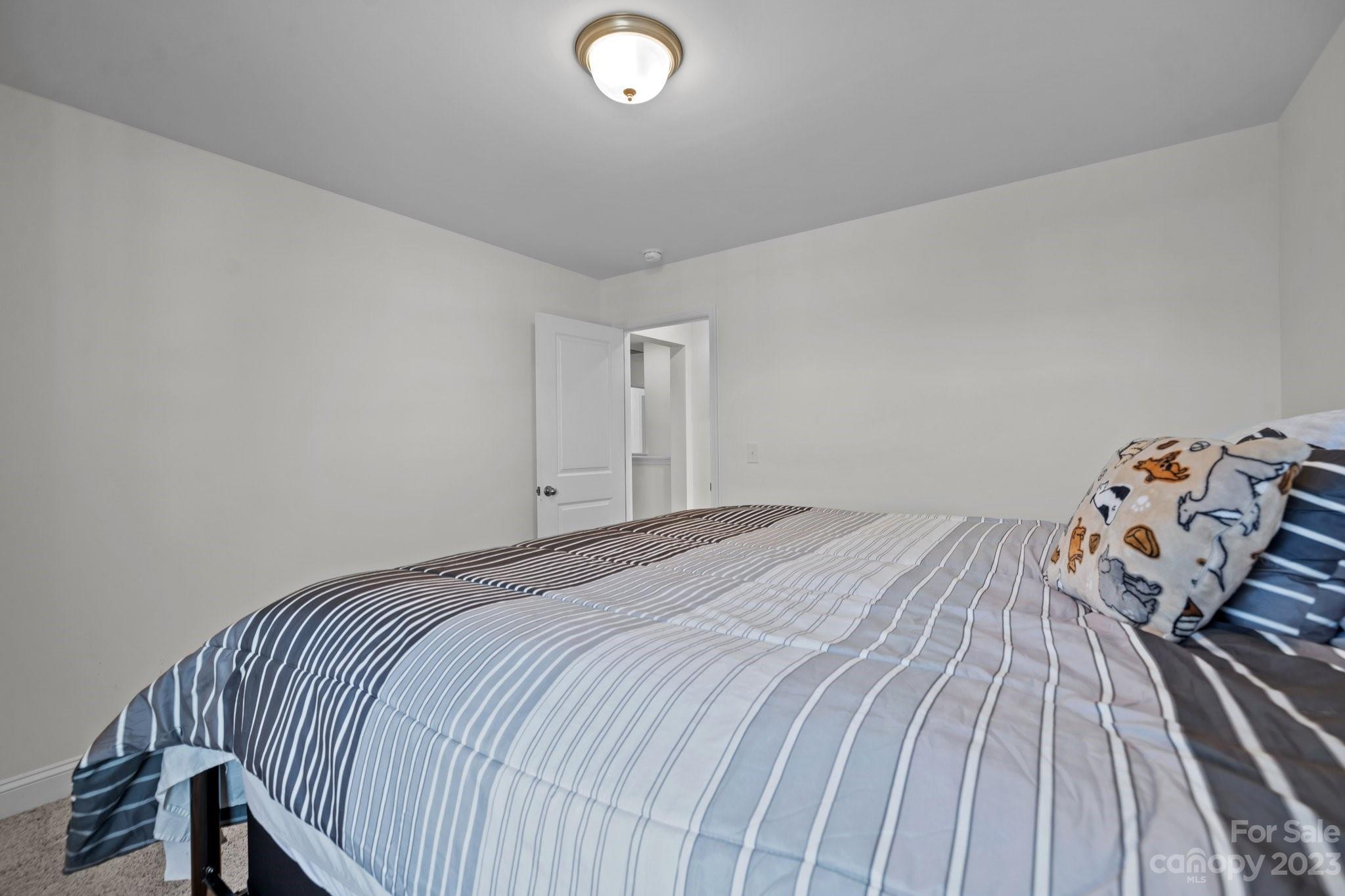 2075 Suttonview Road Fort Mill, SC 29708 - Photo 19 of 39 a bedroom with a bed and wooden floor