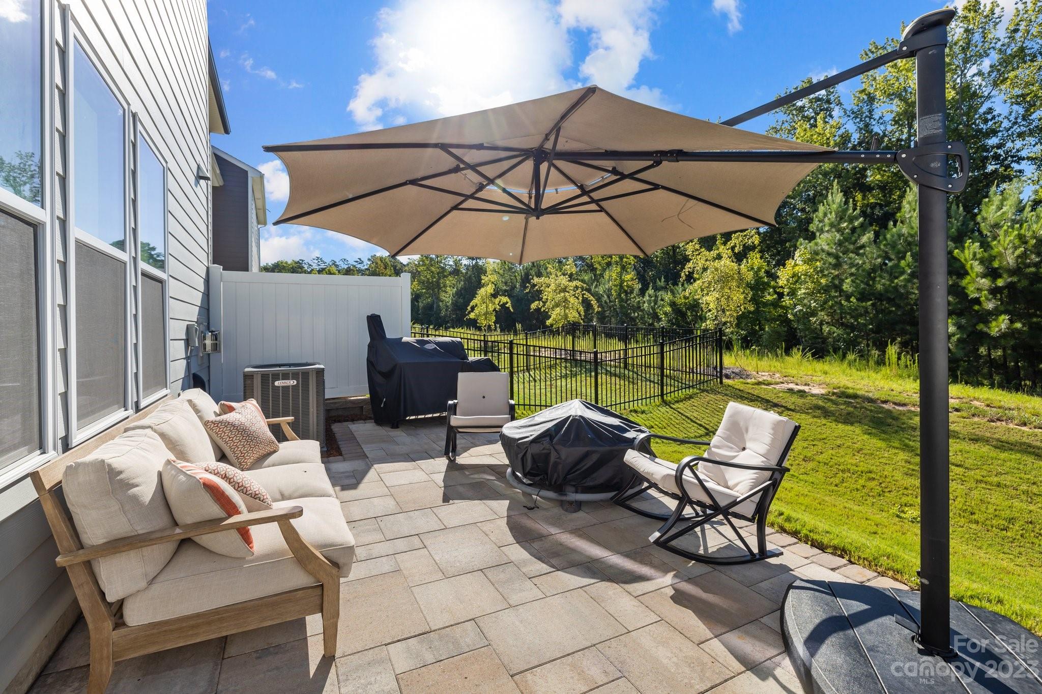 2075 Suttonview Road Fort Mill, SC 29708 - Photo 29 of 39 a view of a patio with a table chairs and a umbrella