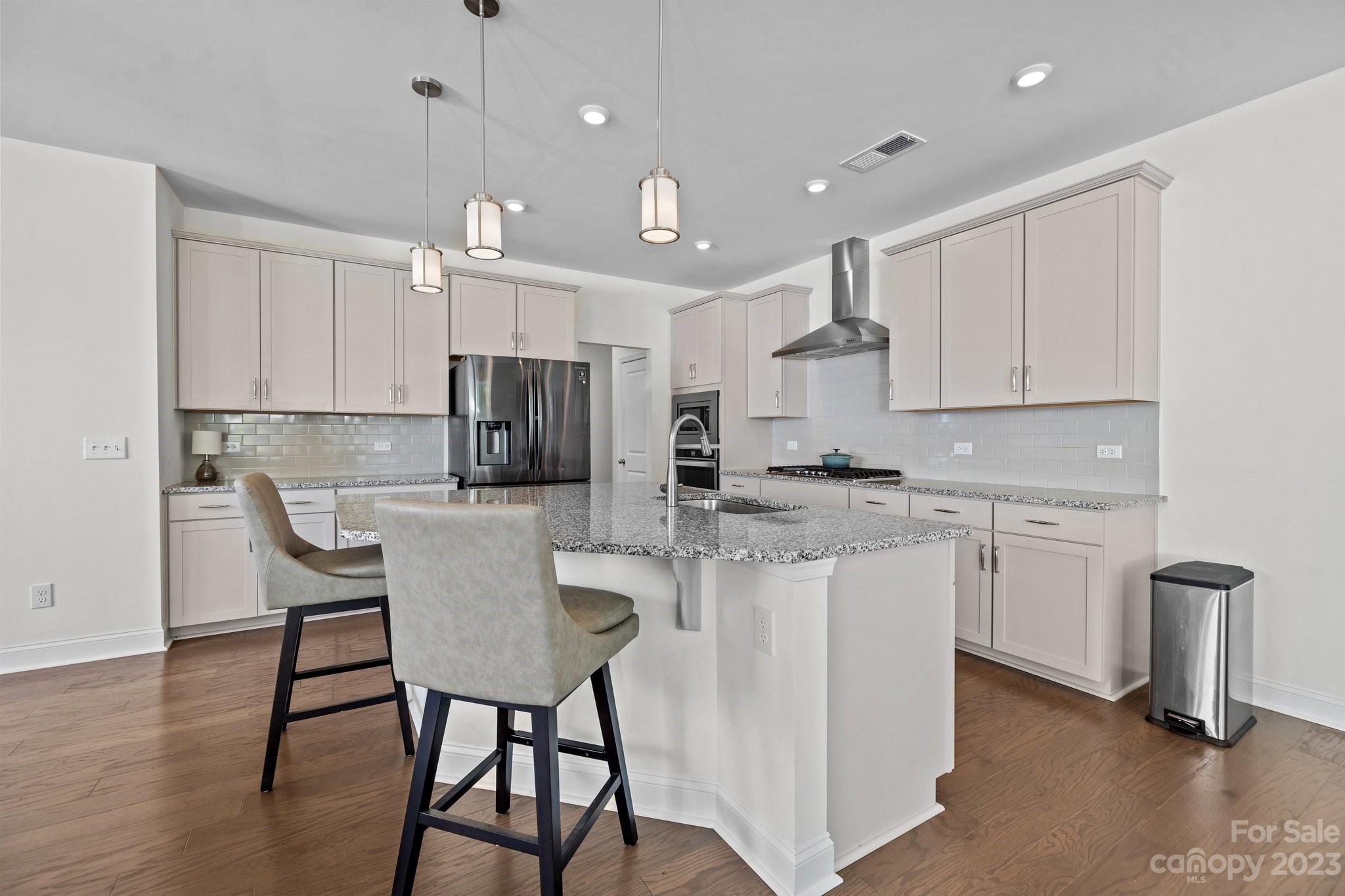 2075 Suttonview Road Fort Mill, SC 29708 - Photo 3 of 39 a kitchen with kitchen island a dining table chairs stainless steel appliances and cabinets