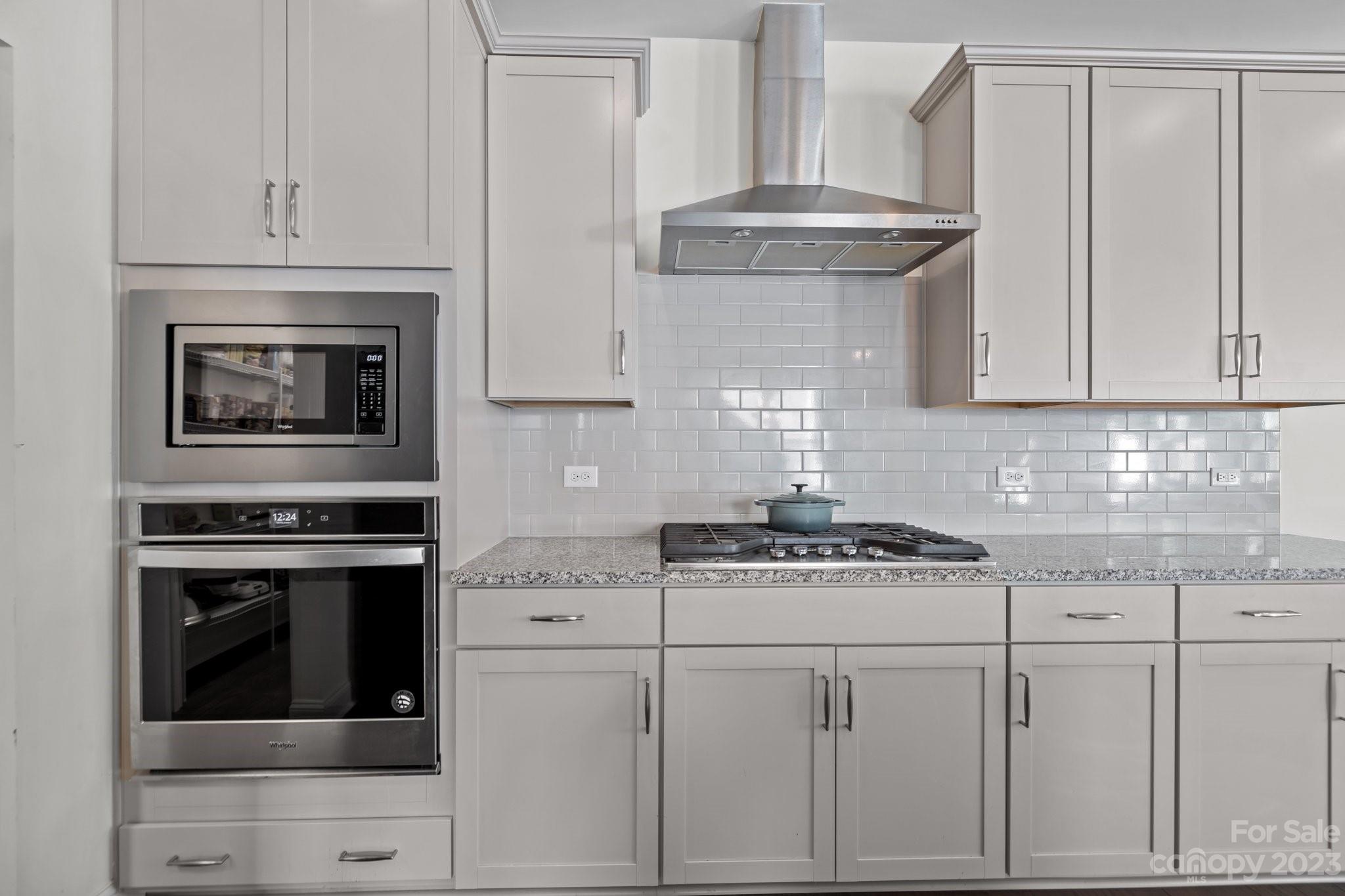 2075 Suttonview Road Fort Mill, SC 29708 - Photo 4 of 39 a kitchen with granite countertop white cabinets and stainless steel appliances