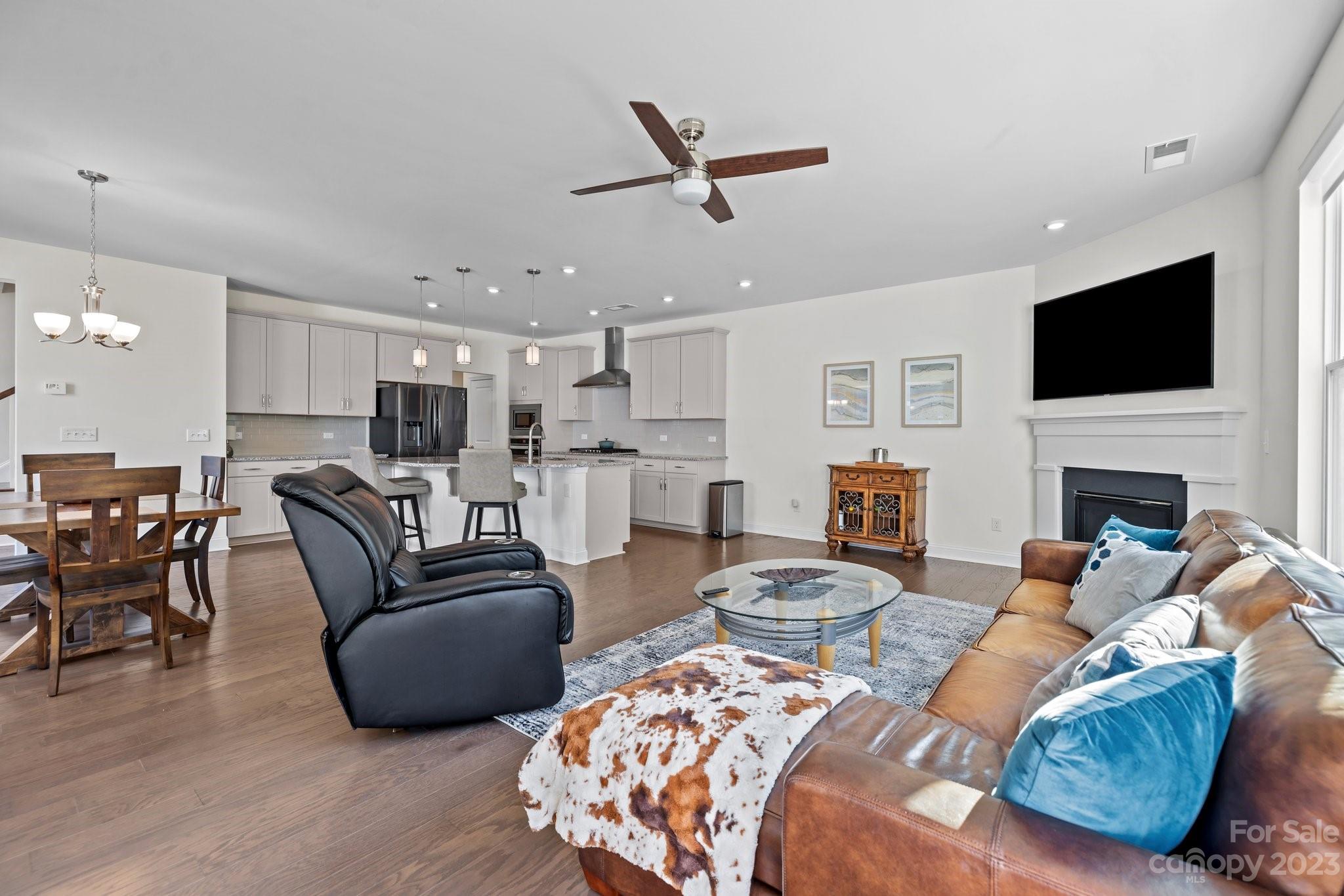 2075 Suttonview Road Fort Mill, SC 29708 - Photo 10 of 39 a living room with furniture fireplace and a flat screen tv