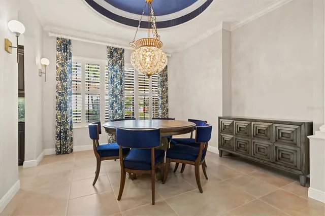 a dining room with furniture a chandelier and a rug
