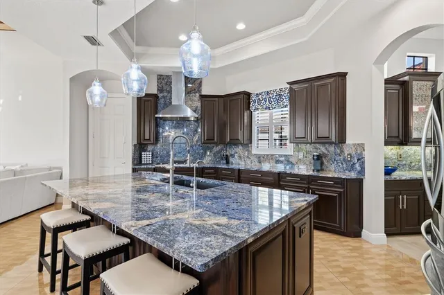 an aerial view of residential houses with outdoor space and ocean view