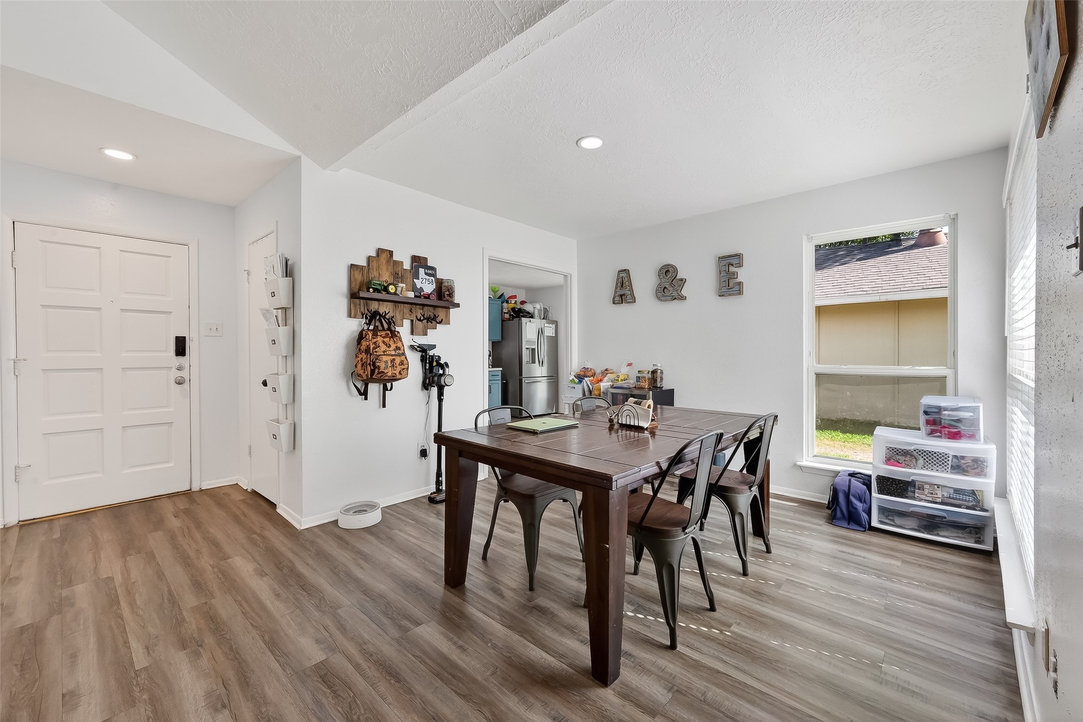 2526 Spring Dusk Drive Spring, TX 77373 - Photo 12 of 33 a view of a dining room with furniture and wooden floor