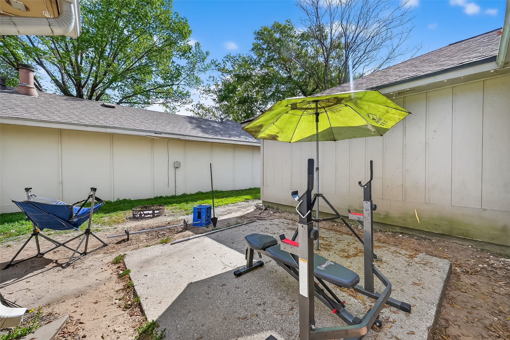 2526 Spring Dusk Drive Spring, TX 77373 - Photo 29 of 33 a view of a backyard with table and chairs under an umbrella