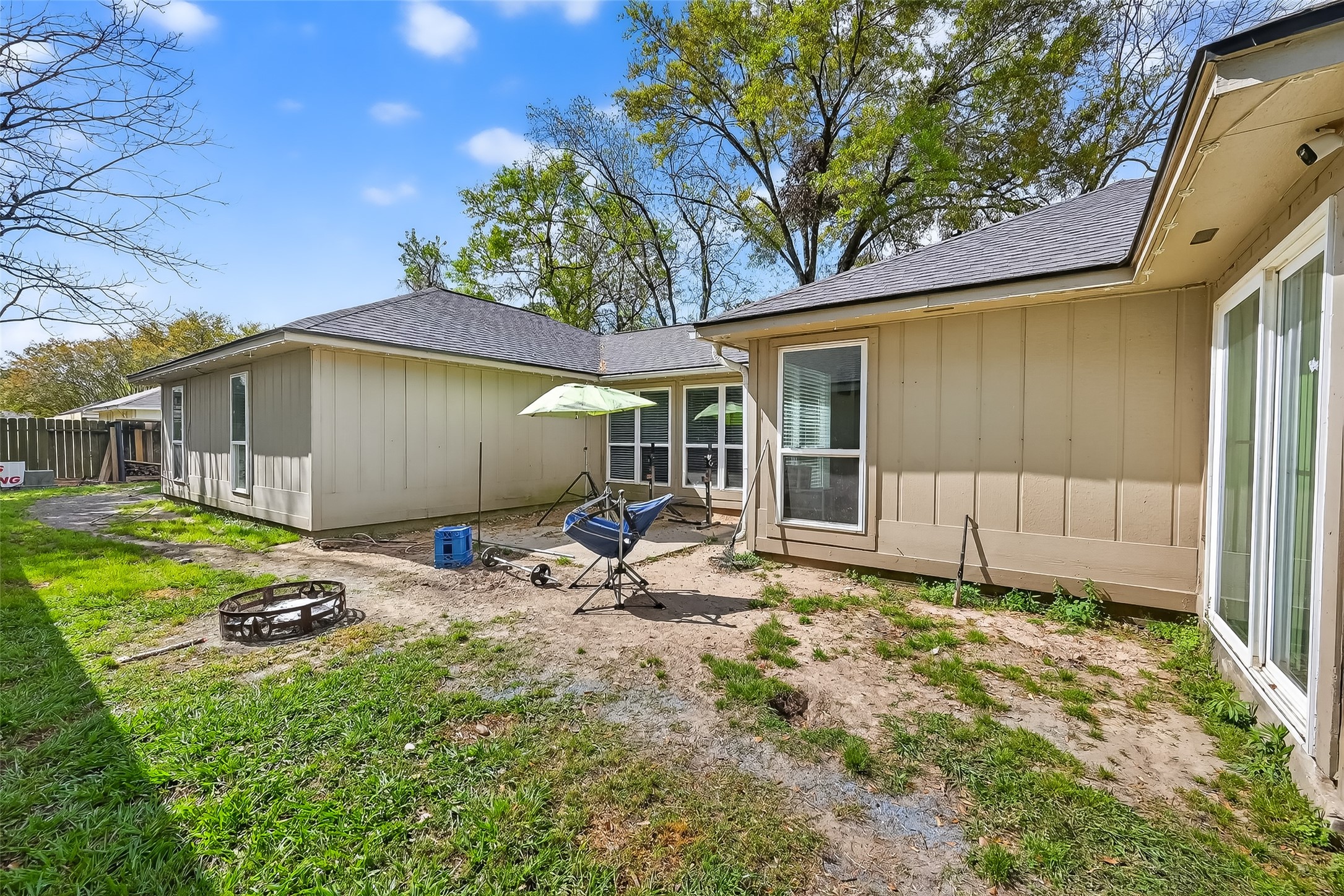 2526 Spring Dusk Drive Spring, TX 77373 - Photo 33 of 33 a backyard of a house with table and chairs under an umbrella