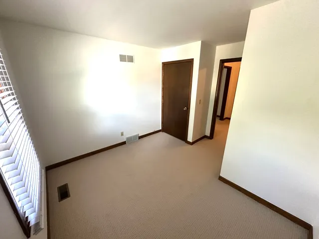 a view of a storage & utility room with refrigerator