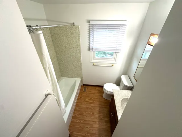 a view of hallway with furniture and a window