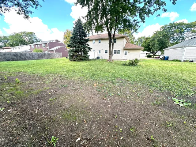a view of house with backyard