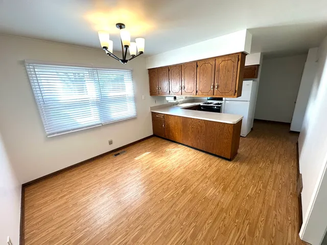 a view of kitchen with granite countertop cabinets and wooden floor