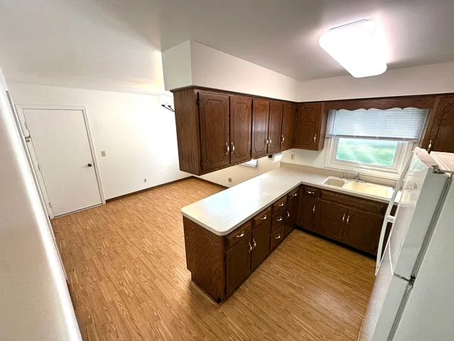 a kitchen with a refrigerator and a sink