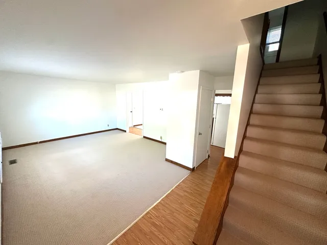 a view of a room with wooden floor and stairs