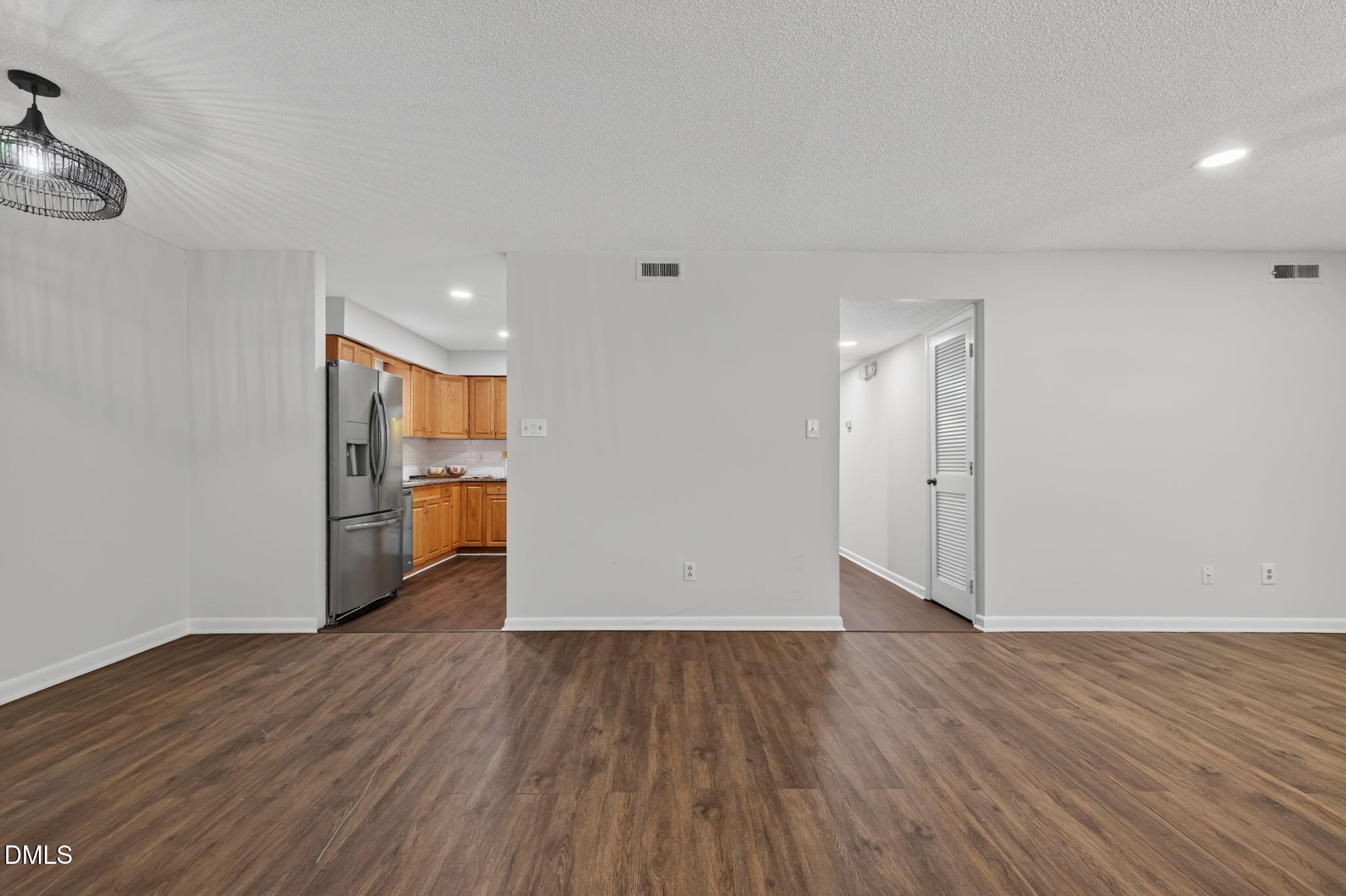 546 Pine Ridge Place Raleigh, NC 27609 - Photo 8 of 21 a view of empty room with wooden floor