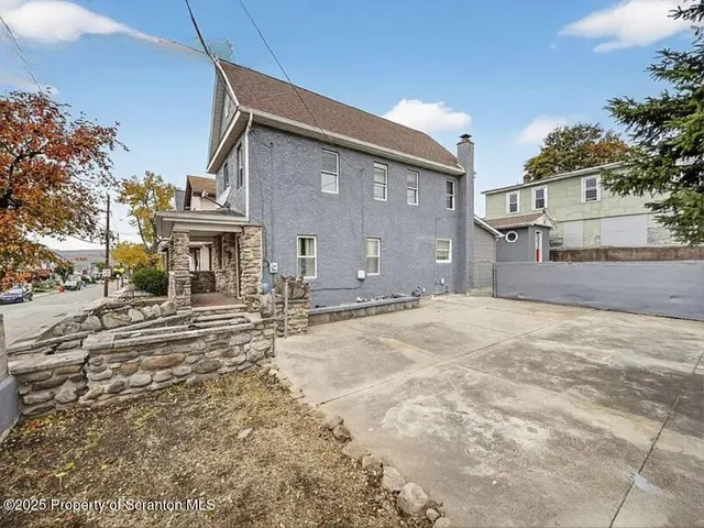 a view of a house with a snow on the road