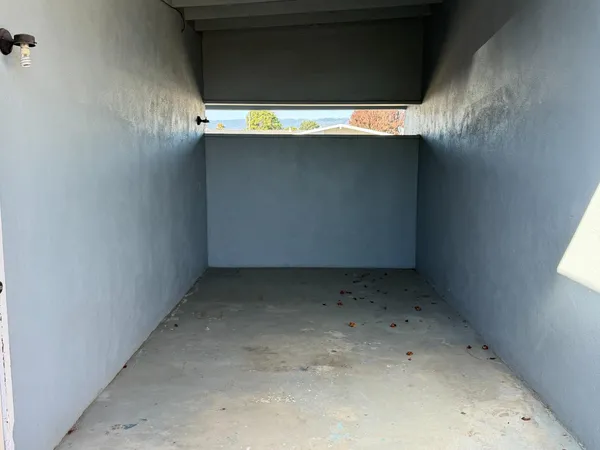 a view of garden with wooden fences