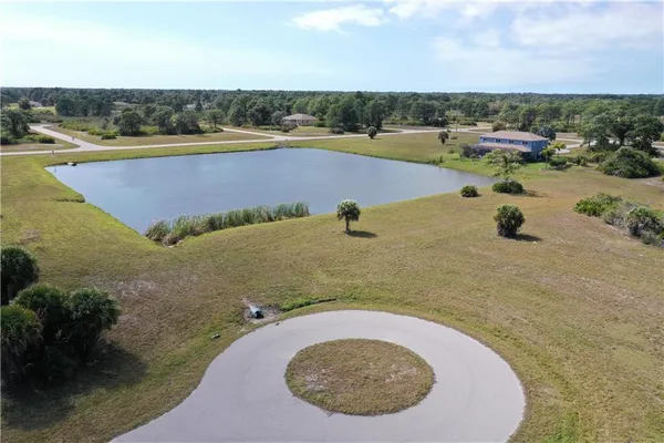 an aerial view of a swimming pool with a yard