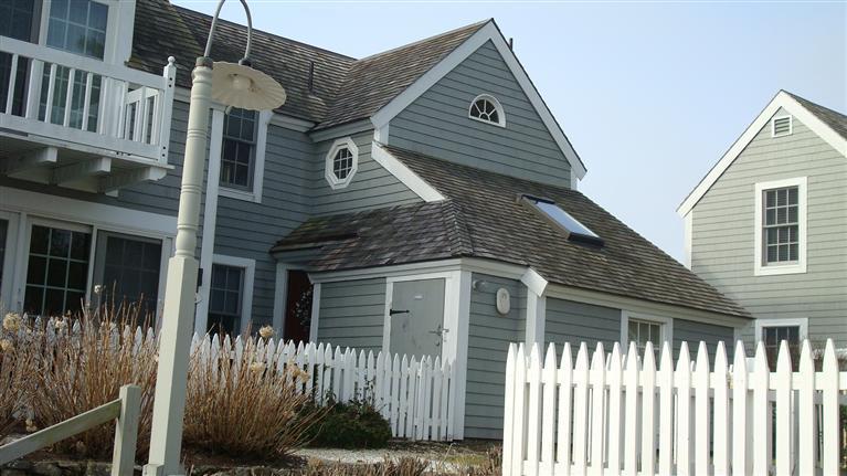 18 Brant Rock Road, Unit 18 Mashpee, MA 02649 - Photo 1 of 13 a front view of a house with a yard