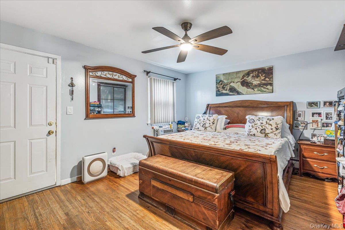 132-14 Horace Harding Expressway Queens, NY 11367 - Photo 15 of 25 Bedroom featuring wood finished floors and ceiling fan