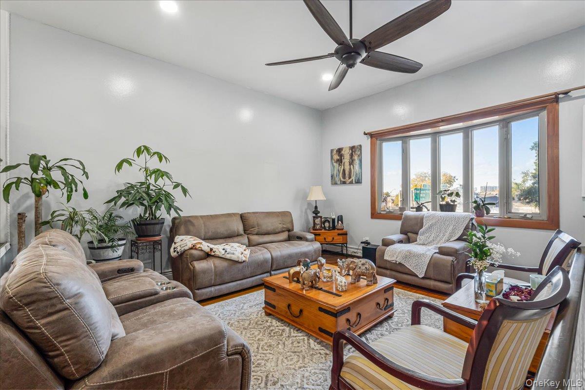 132-14 Horace Harding Expressway Queens, NY 11367 - Photo 10 of 25 Living room featuring wood finished floors, ceiling fan, and recessed lighting