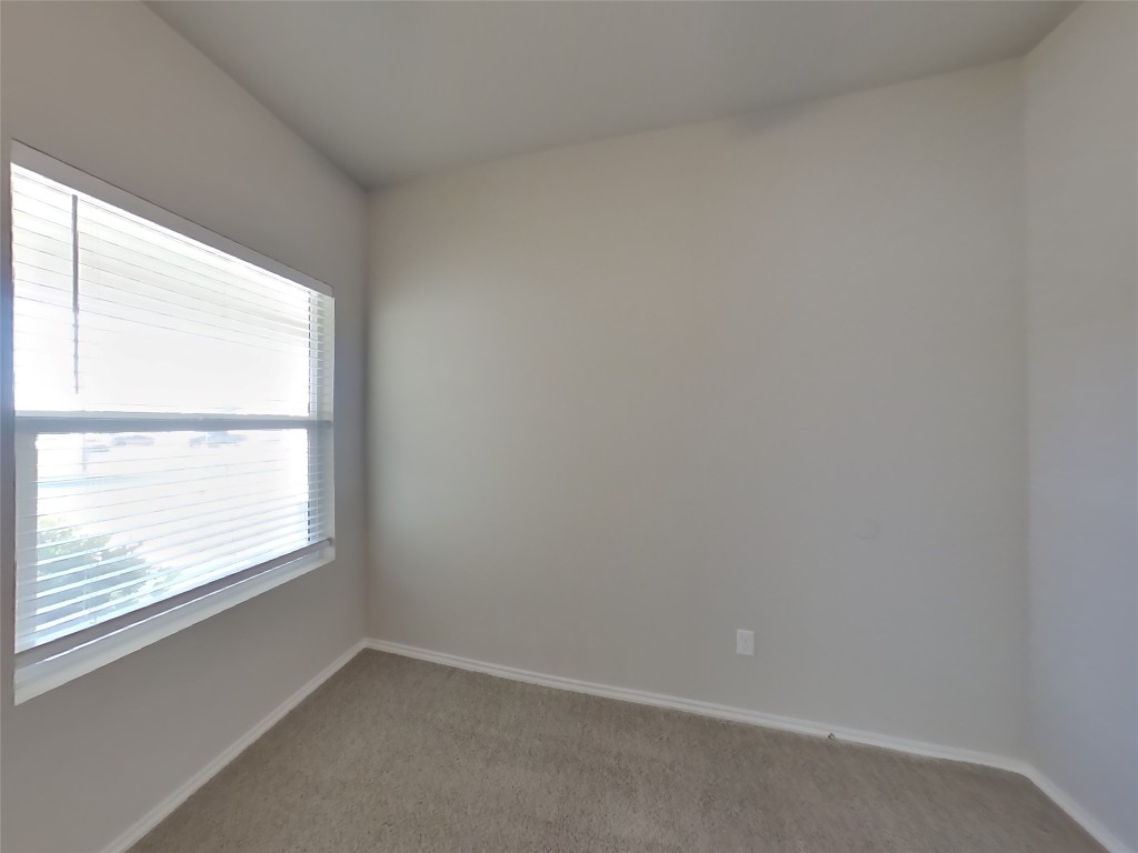 5205 Sidesaddle Drive Georgetown, TX 78626 - Photo 11 of 26 Spare room featuring light colored carpet and baseboards