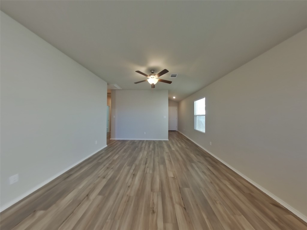 5205 Sidesaddle Drive Georgetown, TX 78626 - Photo 2 of 26 Unfurnished room with light wood finished floors and ceiling fan