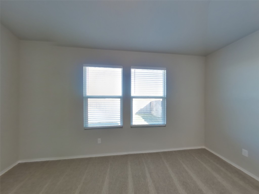 5205 Sidesaddle Drive Georgetown, TX 78626 - Photo 5 of 26 Empty room with healthy amount of natural light and light carpet