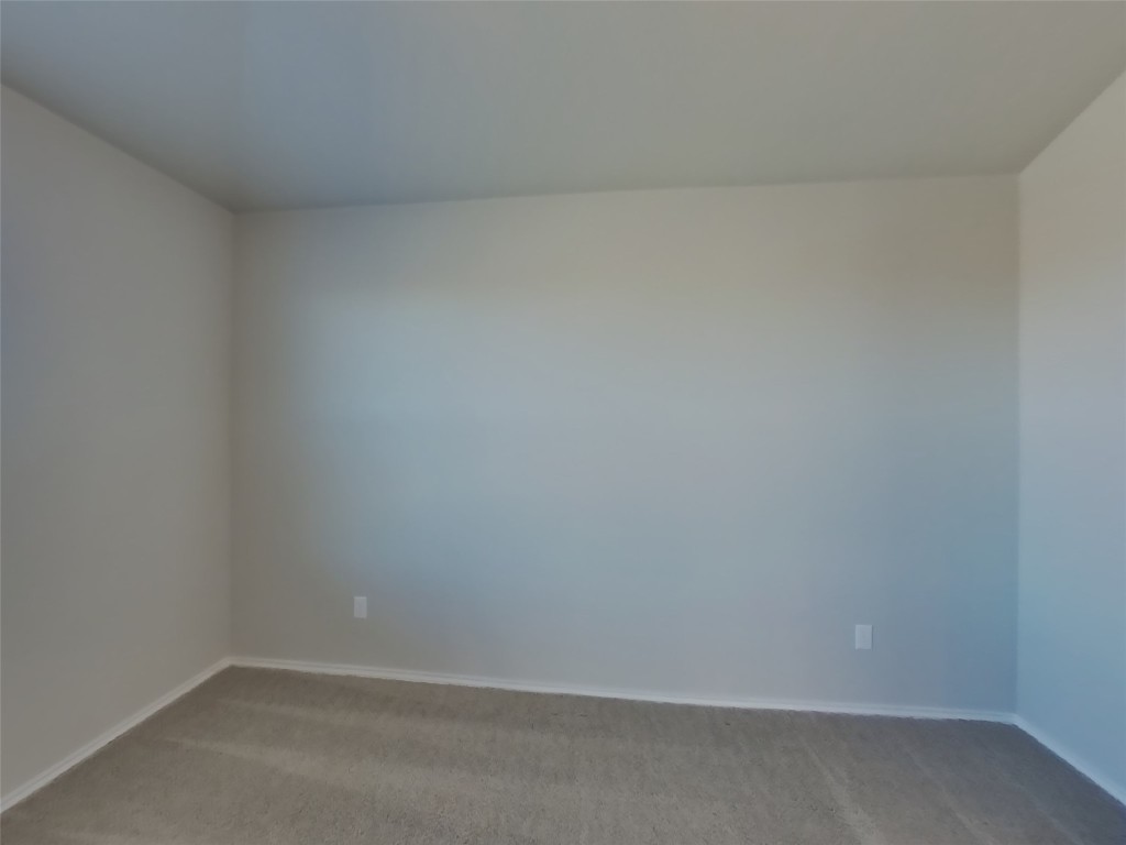 5205 Sidesaddle Drive Georgetown, TX 78626 - Photo 6 of 26 Empty room with light colored carpet and baseboards
