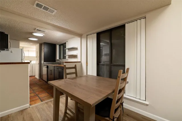 a kitchen with a table and chairs