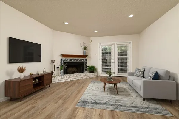 a living room with furniture a flat screen tv and a fireplace
