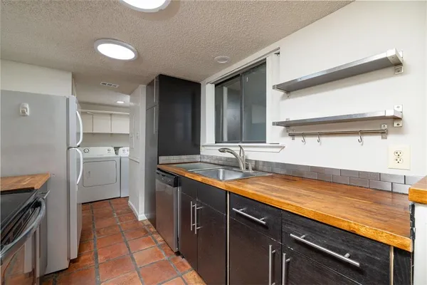 a kitchen with a sink stove and cabinets