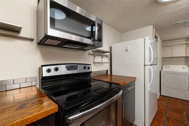 a stove top oven sitting inside of a kitchen