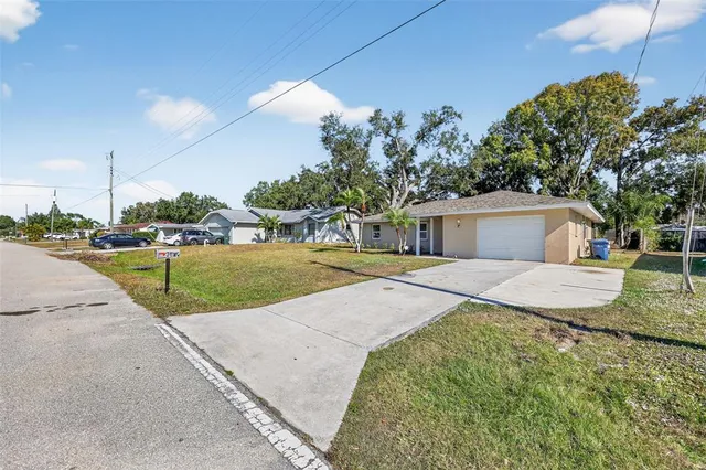 a front view of a house with a yard and trees