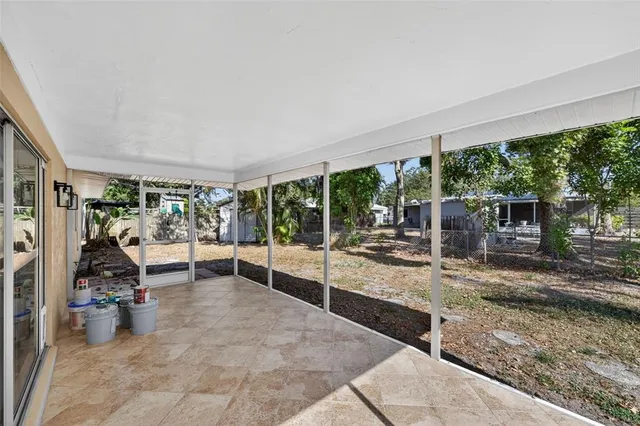 a view of a patio with table and chairs next to a yard