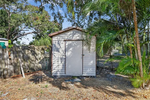 a view of a house with a tree in the background