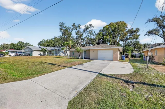 a front view of a house with a yard and trees