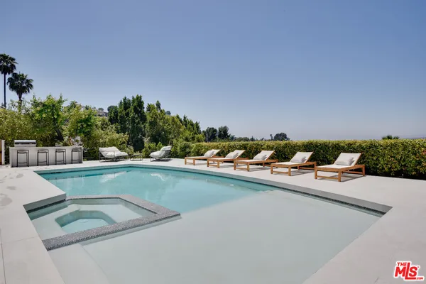 a view of a swimming pool with chairs