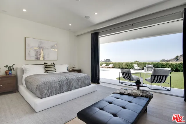 a living room with furniture and a floor to ceiling window