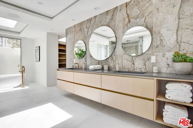 a bathroom with a double vanity sink and a mirror
