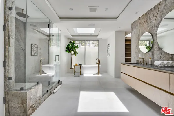 a living room with furniture and a large mirror