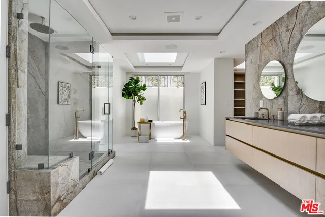 a living room with furniture and a large mirror