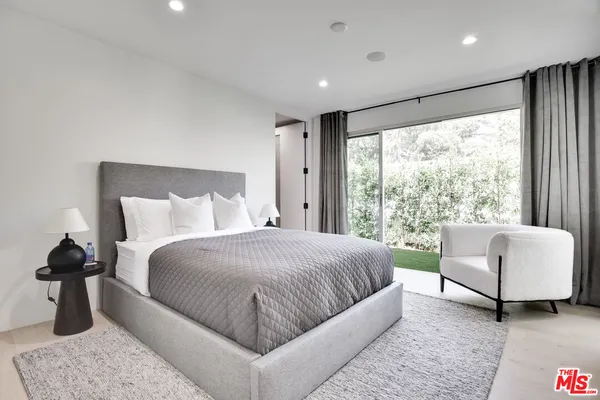 a bedroom with a large bed and a large window