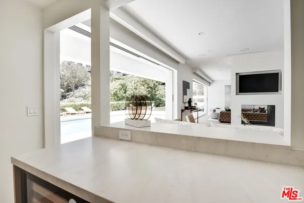 a living room with a large window and a flat screen tv