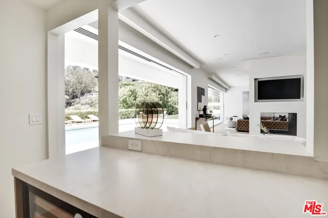 a living room with a large window and a flat screen tv