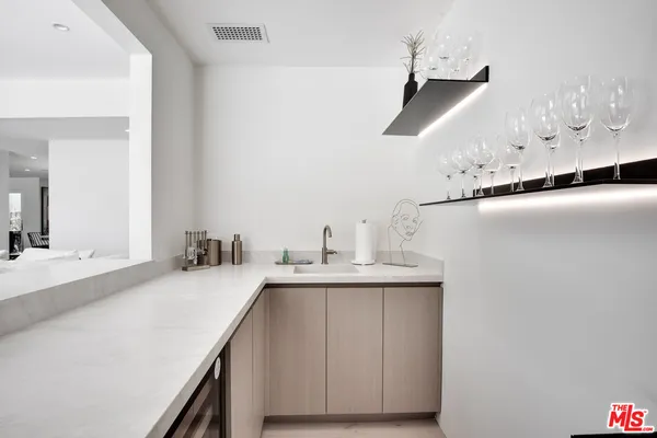 a kitchen with kitchen island a sink appliances and cabinets