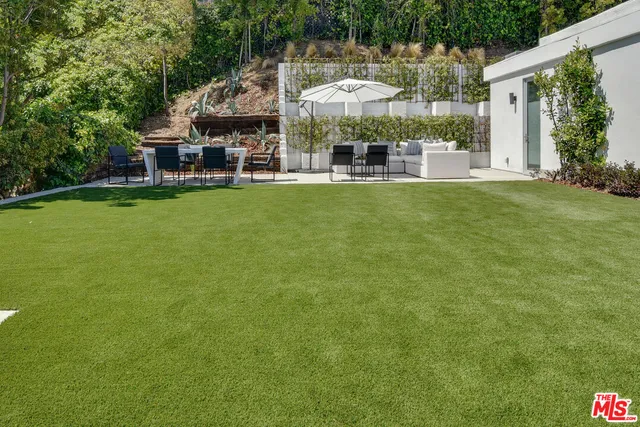 a view of a house with a yard porch and sitting area