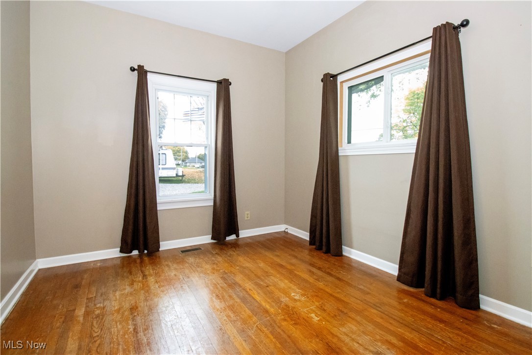 5699 Massillon Road Dalton, OH 44618 - Photo 12 of 24 Spare room with a healthy amount of sunlight and wood-type flooring