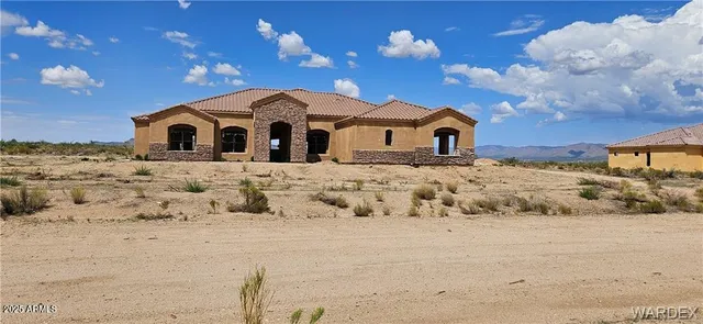 a view of a house with a yard covered in snow