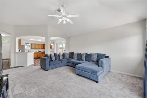 a living room with furniture and a chandelier